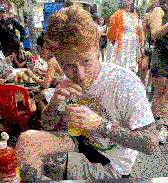 Oscar drinking through a straw at a street food table